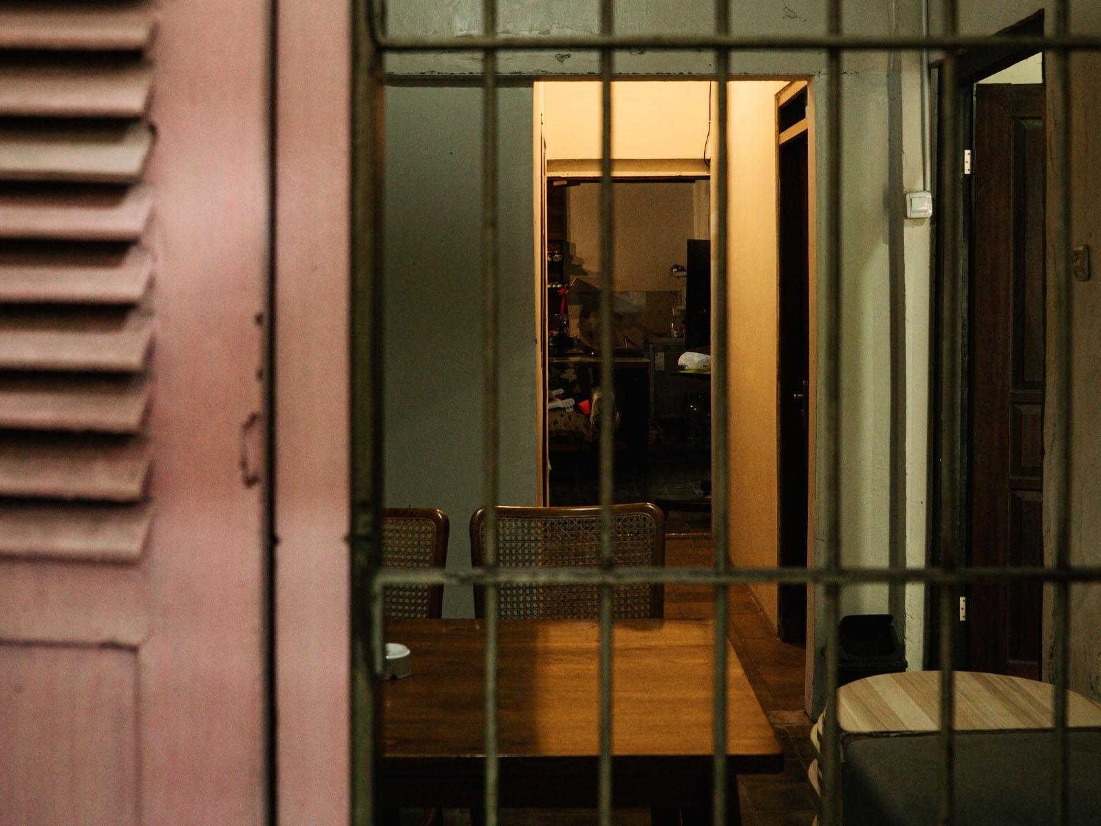 A café corner with antique wooden doors and tables.
