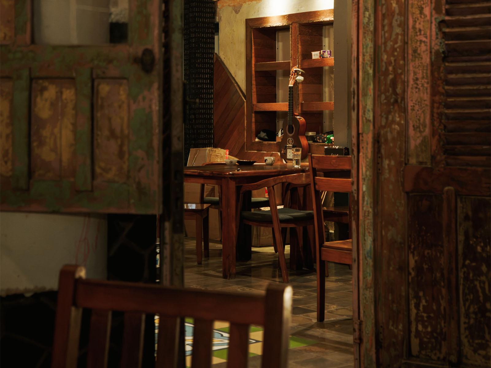 A dining room with wooden tables and antique furniture.