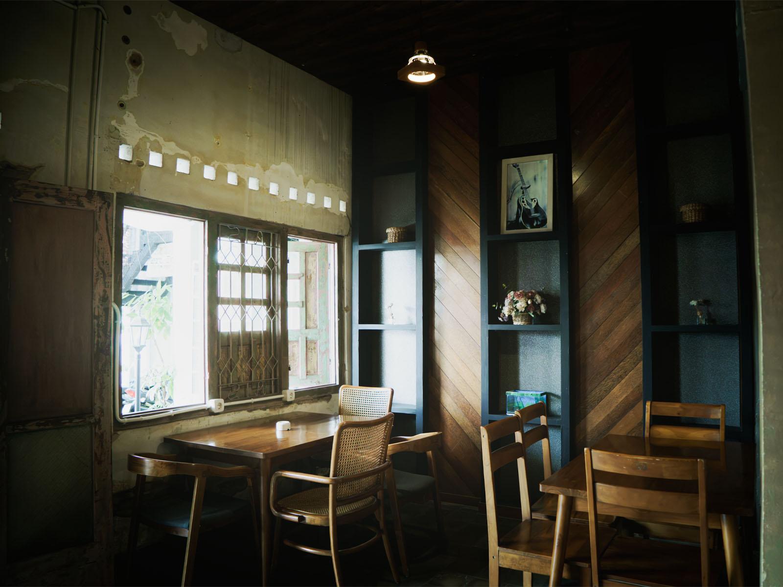 The café interior with wooden tables and stained-glass windows.